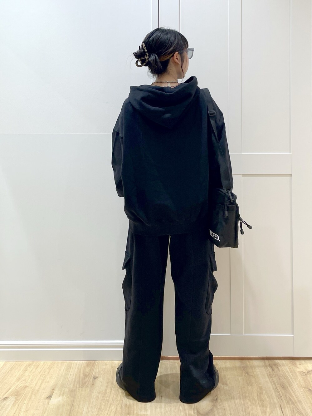 ブラック系のブーツ、ブラック系のスウェットパンツ、ブラック系のパーカーを着用したレディースの夏コーディネートの4枚目の写真