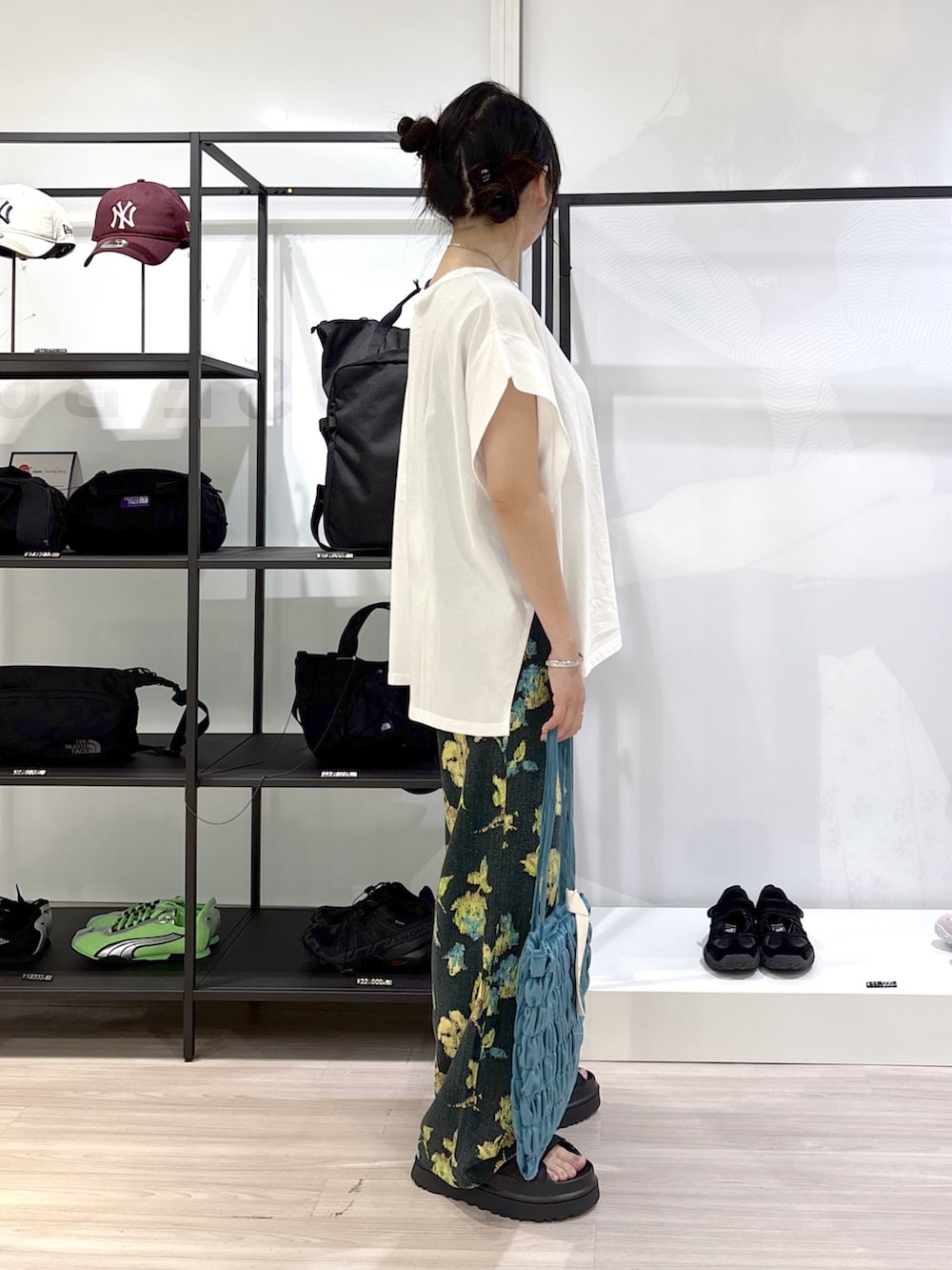 ホワイト系のTシャツ/カットソー、グリーン系のその他パンツ、ブラック系のサンダルを着用したレディースの春コーディネートの5枚目の写真