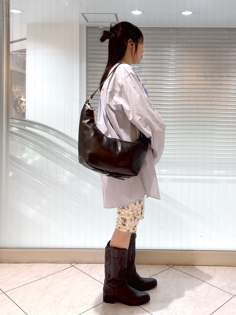 ブラック系のブーツ、ブルー系のシャツ/ブラウス、ベージュ系のテーラードジャケットを着用したレディースの春コーディネートの7枚目の写真