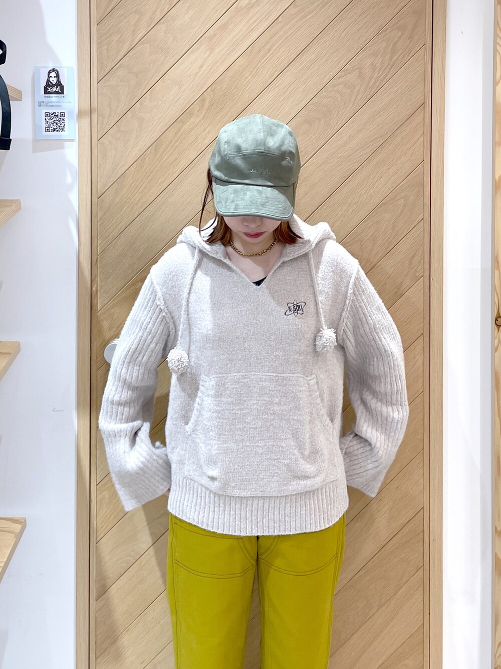 ブラウン系のその他パンツ、ブラック系のスニーカー、ホワイト系のニット/セーターを着用したレディースの秋コーディネートの2枚目の写真