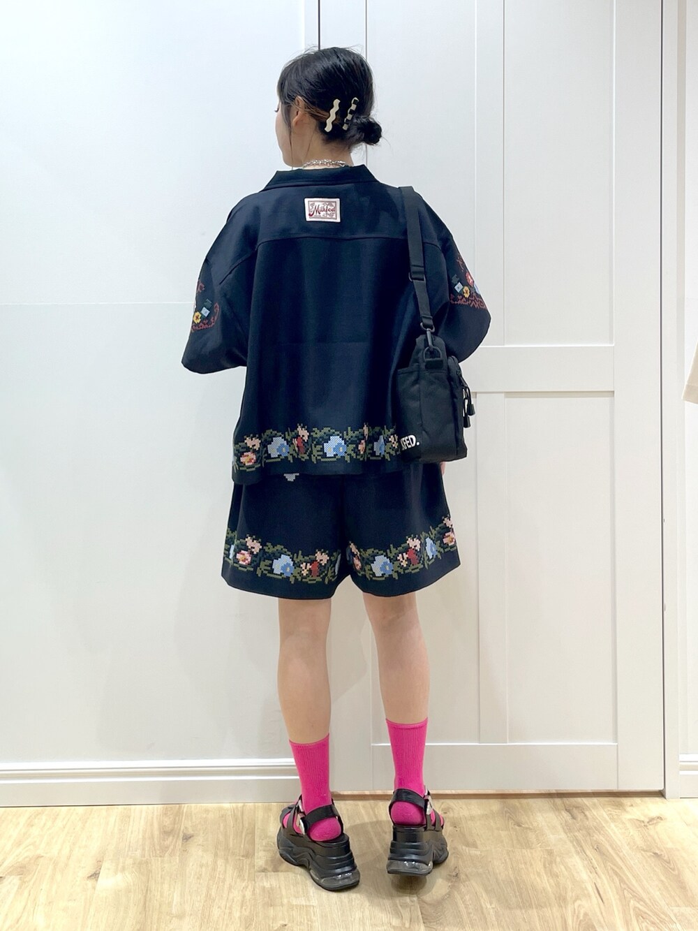 ブラック系のサンダル、ブルー系のその他パンツ、パープル系のショルダーバッグを着用したレディースの夏コーディネートの2枚目の写真