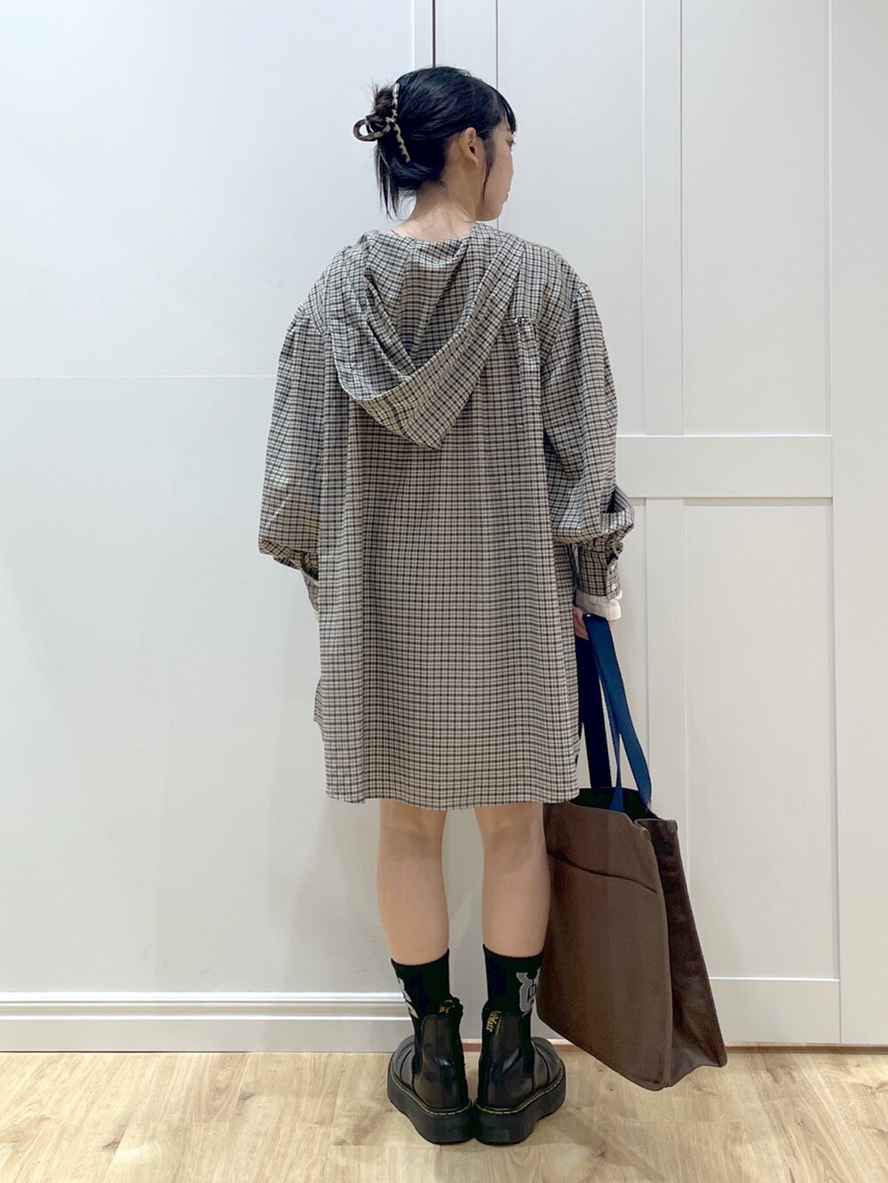 ブラック系のブーツ、ホワイト系のTシャツ/カットソー、ベージュ系のシャツ/ブラウスを着用したレディースの夏コーディネートの5枚目の写真