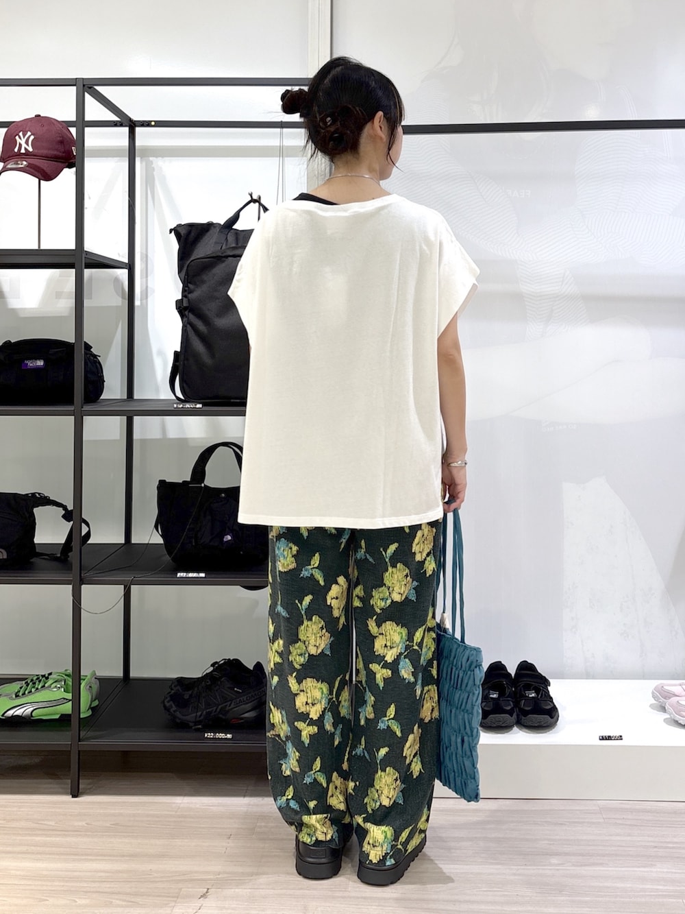 ホワイト系のTシャツ/カットソー、グリーン系のその他パンツ、ブラック系のサンダルを着用したレディースの春コーディネートの6枚目の写真