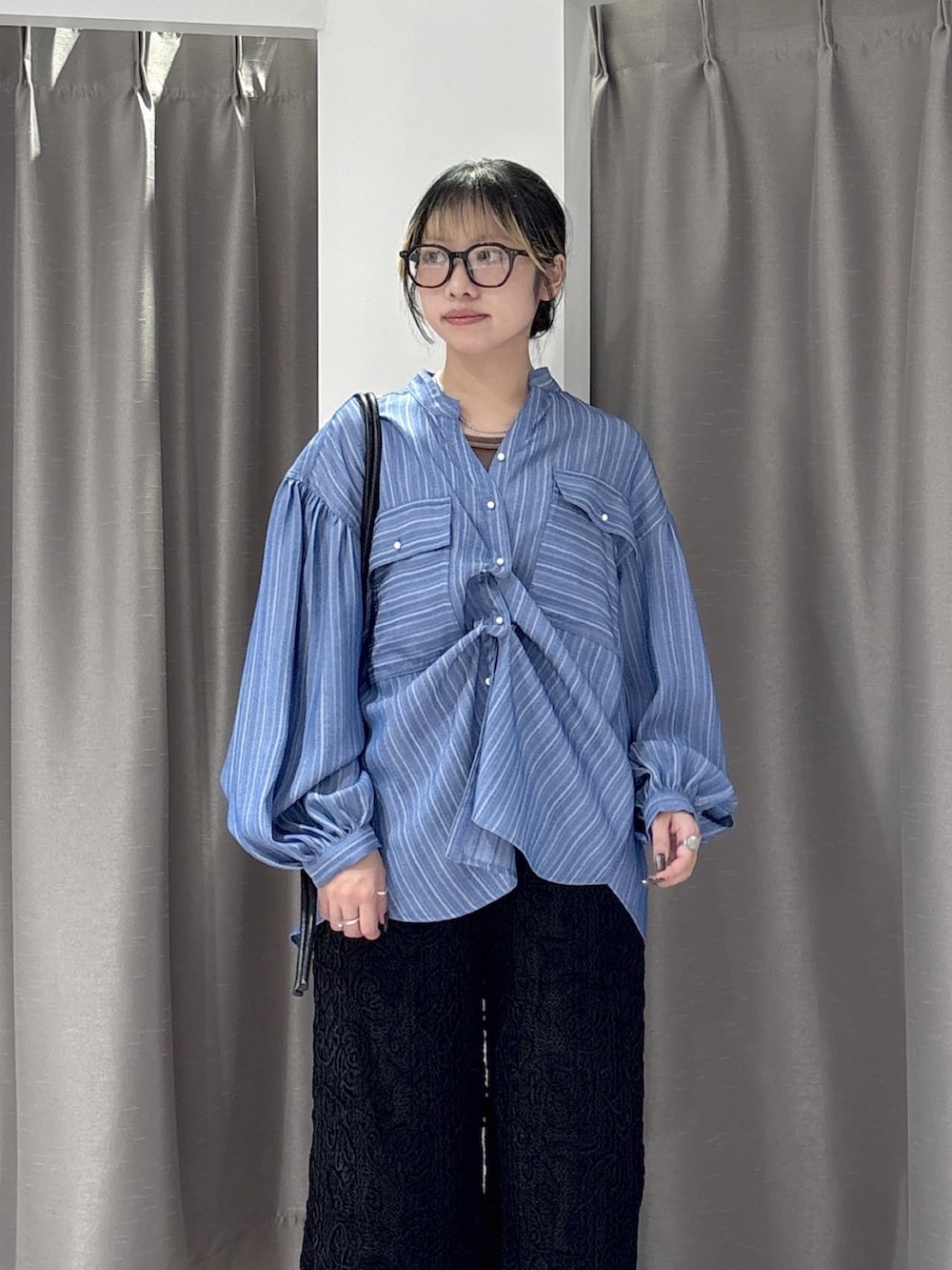 ブルー系のシャツ/ブラウス、ブラウン系のタンクトップ、ブラック系のその他パンツを着用したレディースの秋コーディネートの4枚目の写真