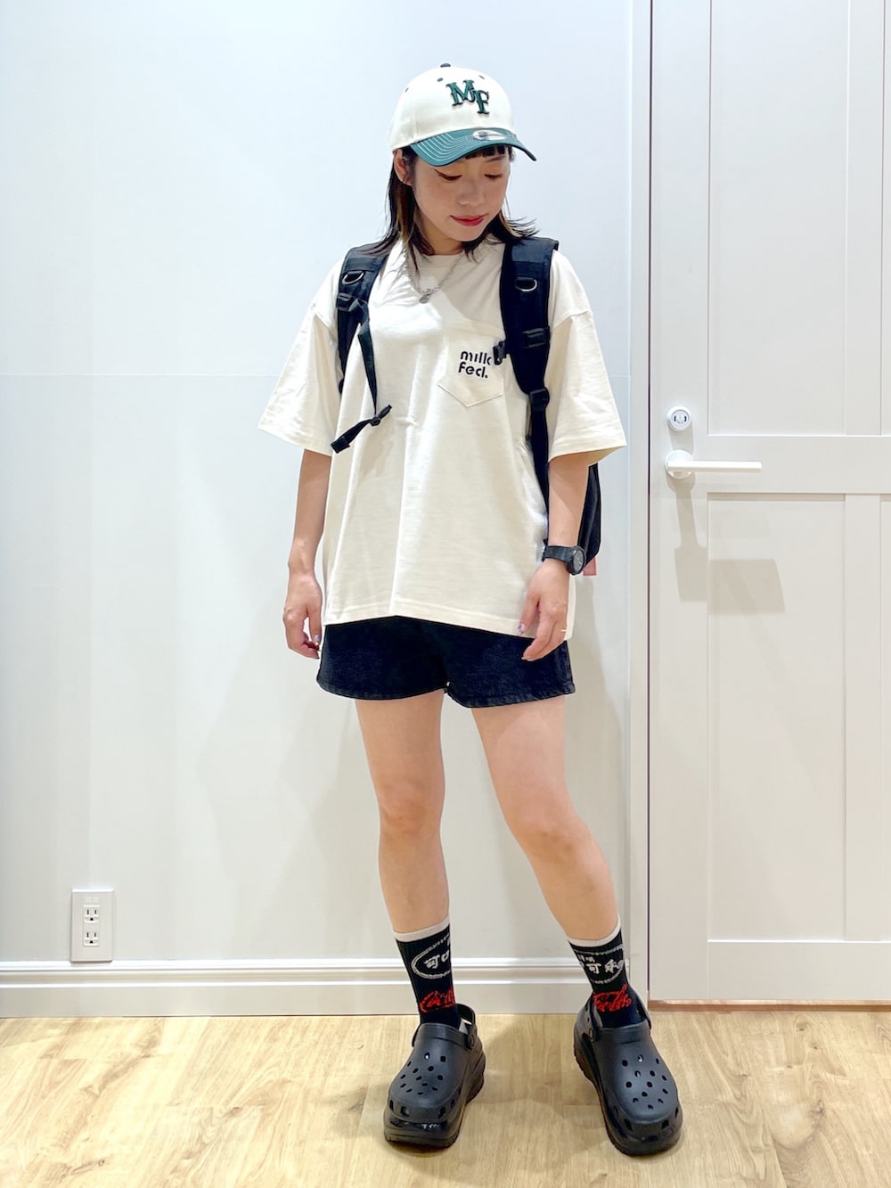 グリーン系のショルダーバッグ、ブラック系のサンダル、ピンク系のバックパック/リュックを着用したレディースの夏コーディネートの3枚目の写真