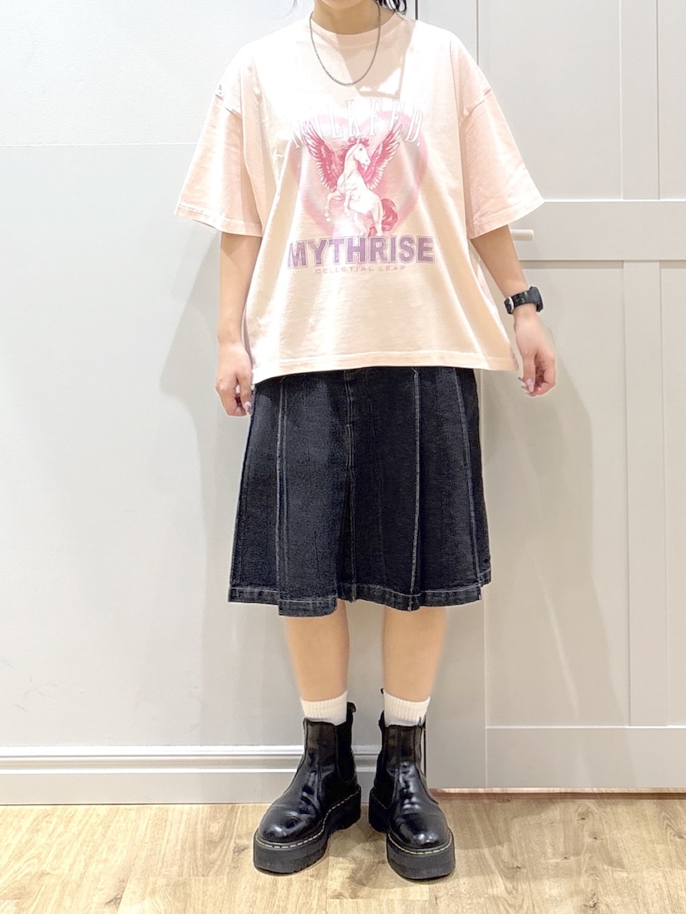 ブラック系のブルゾン、ピンク系のTシャツ/カットソー、ブラック系のデニムスカートを着用したレディースの春コーディネートの6枚目の写真