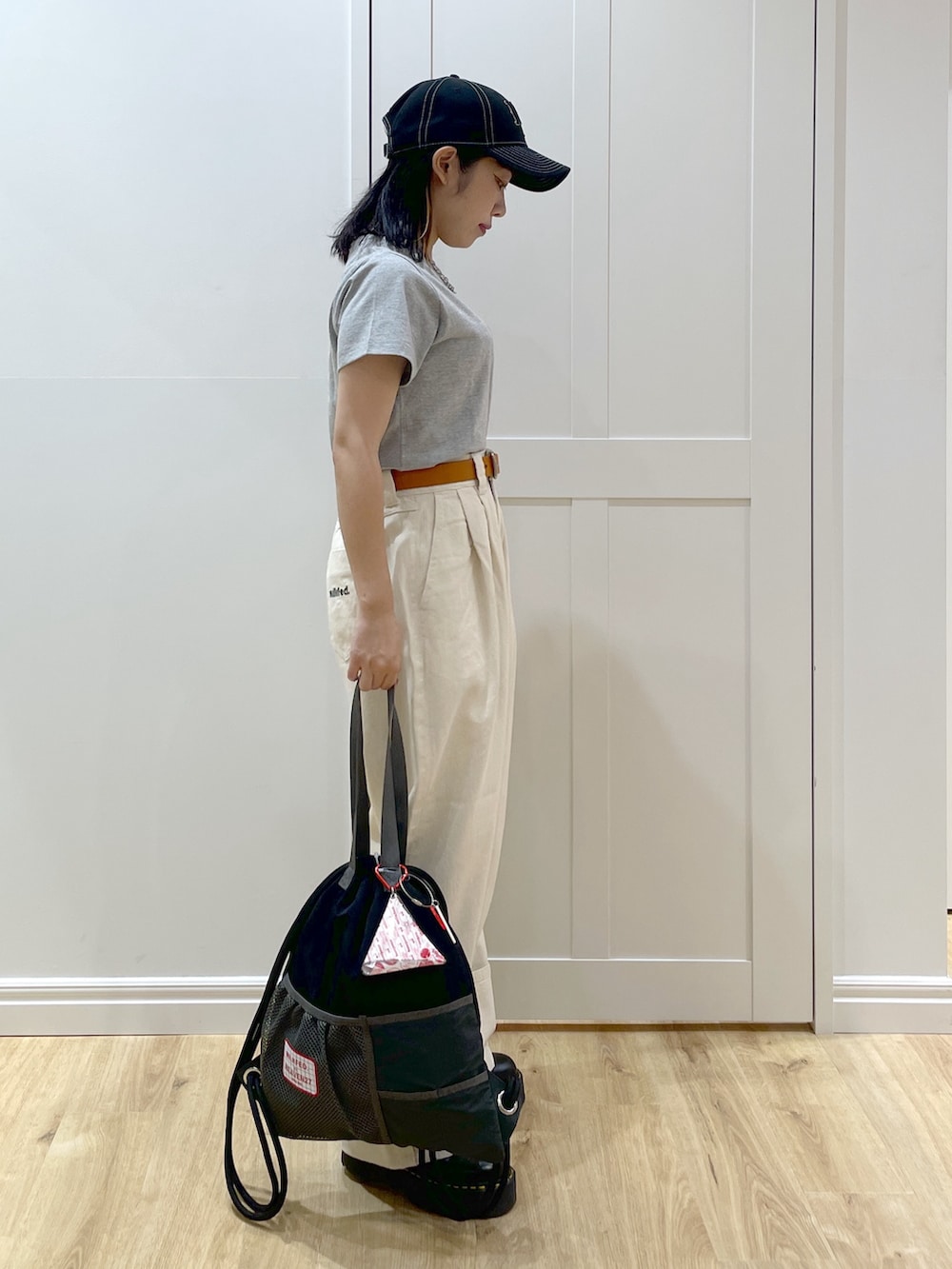 ホワイト系のデニムパンツ、ブラック系のブーツ、グレー系のTシャツ/カットソーを着用したレディースの夏コーディネートの2枚目の写真