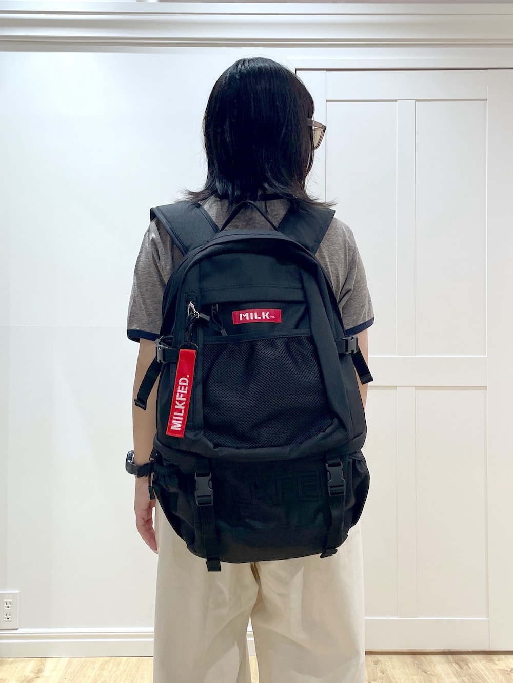 ホワイト系のその他パンツ、グレー系のTシャツ/カットソー、レッド系のバックパック/リュックを着用したレディースの夏コーディネートの5枚目の写真