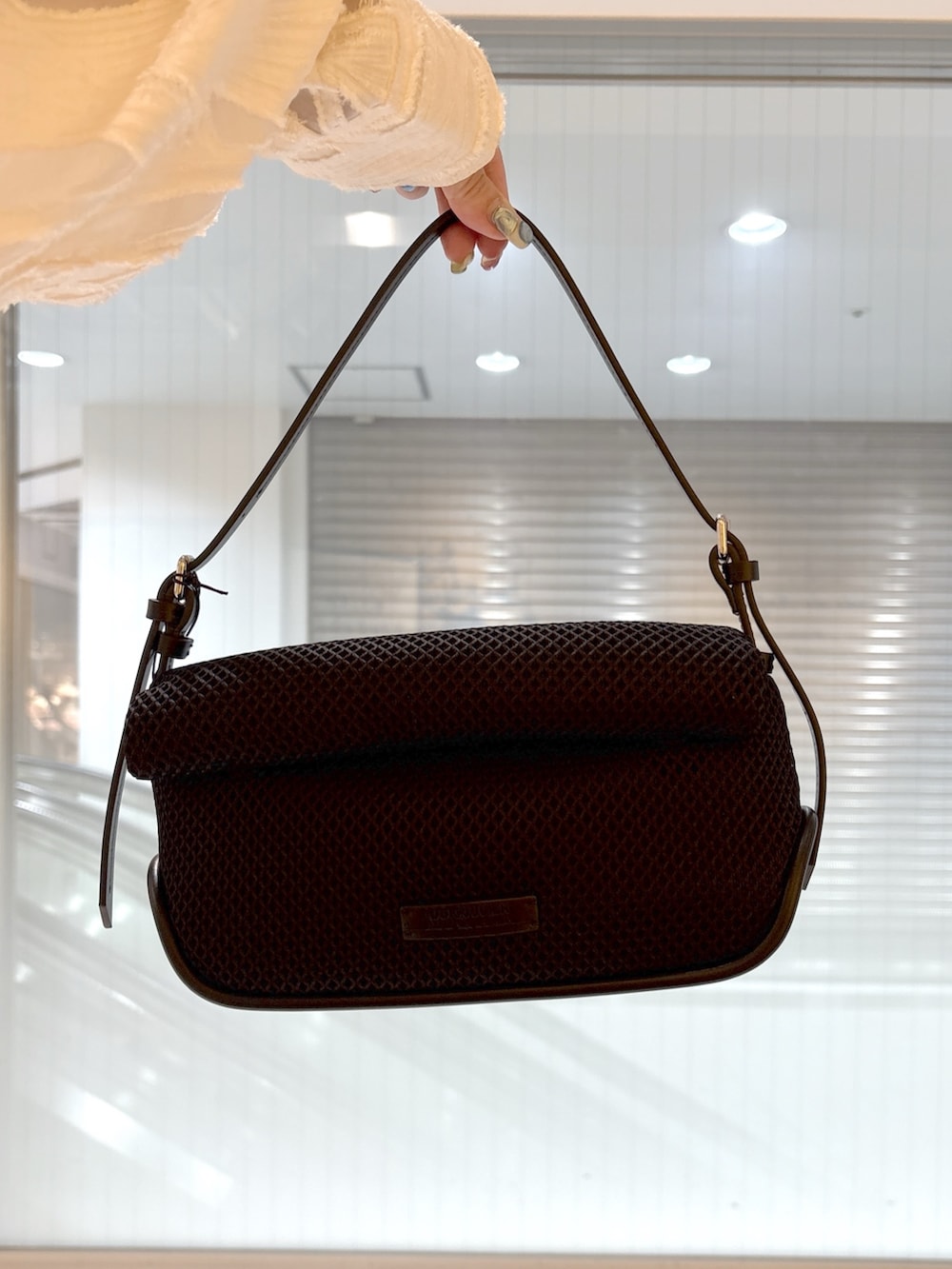 ブラック系のブーツ、ホワイト系のTシャツ/カットソー、ブラック系のショルダーバッグを着用したレディースの春コーディネートの6枚目の写真