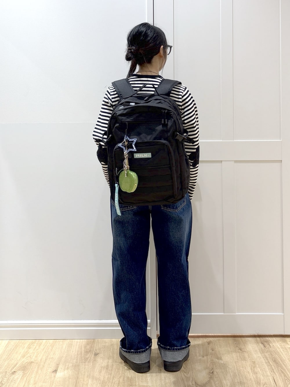 ブルー系のデニムパンツ、ブラック系のブーツ、ブラック系のカーディガン/ボレロを着用したレディースの春コーディネートの4枚目の写真