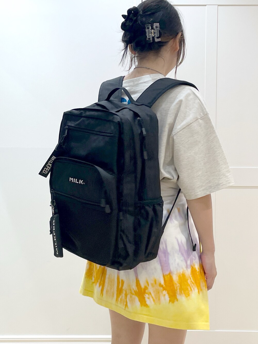 ホワイト系のTシャツ/カットソー、ブラック系のバックパック/リュック、ベージュ系のTシャツ/カットソーを着用したレディースの春コーディネートの4枚目の写真