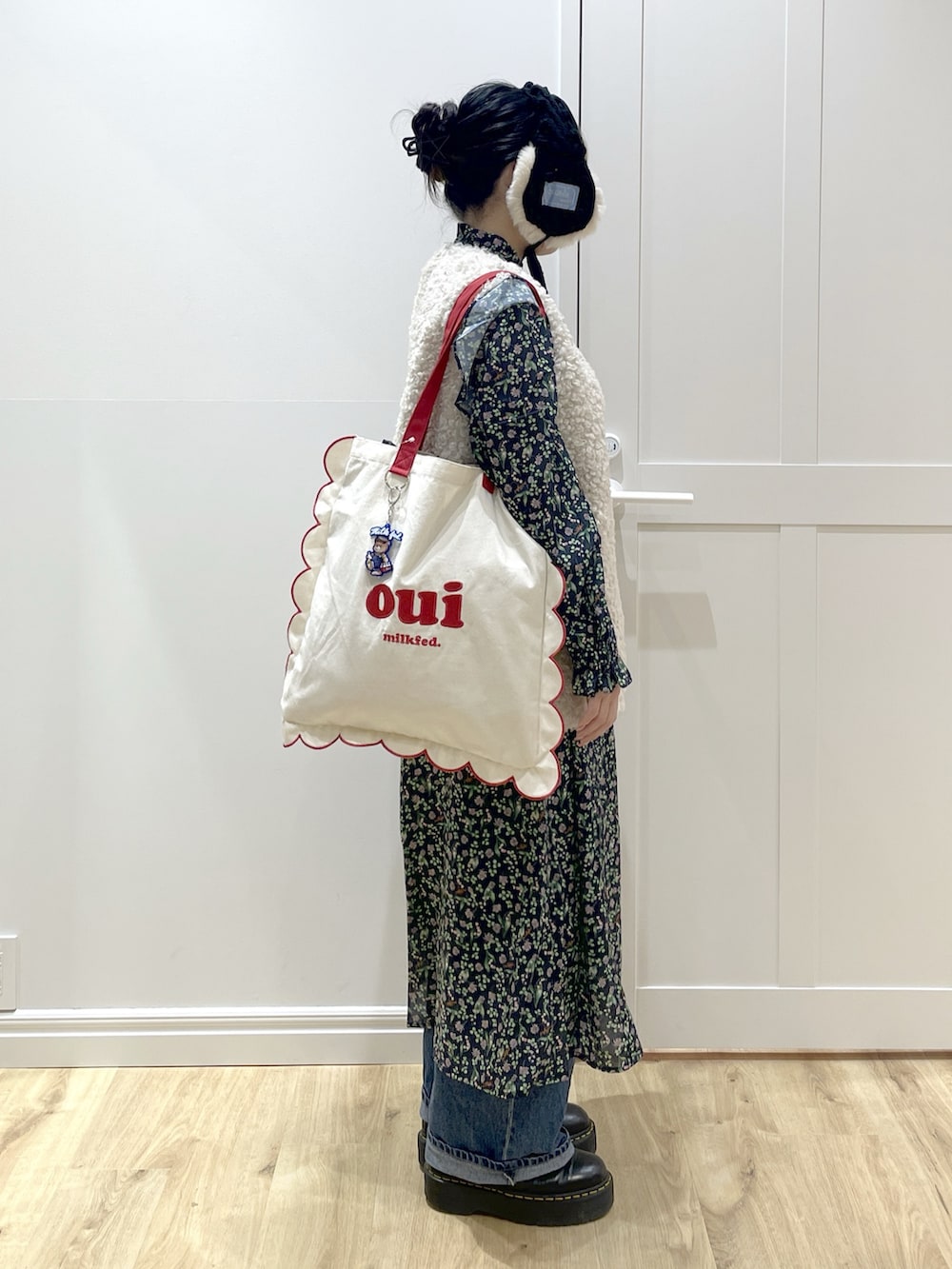 ブルー系のワンピース、ブルー系のデニムパンツ、ブラック系のブーツを着用したレディースの冬コーディネートの4枚目の写真