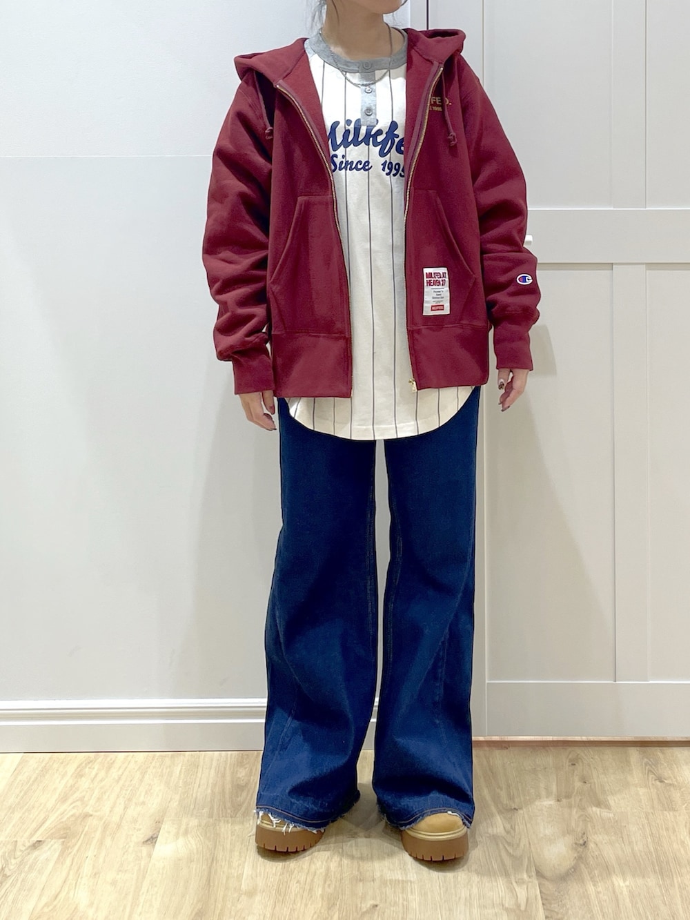 ベージュ系のブーツ、ブルー系のデニムパンツ、ブラック系のベストを着用したレディースの秋コーディネートの7枚目の写真