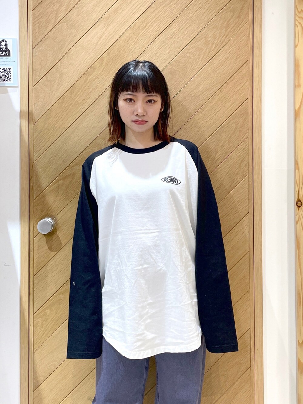 パープル系のデニムパンツ、ブラック系のブーツ、ホワイト系のTシャツ/カットソーを着用したレディースの冬コーディネートの5枚目の写真