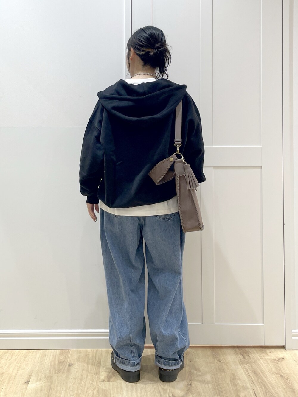 ブラック系のブーツ、ホワイト系のTシャツ/カットソー、ブラック系のパーカーを着用したレディースの秋コーディネートの4枚目の写真