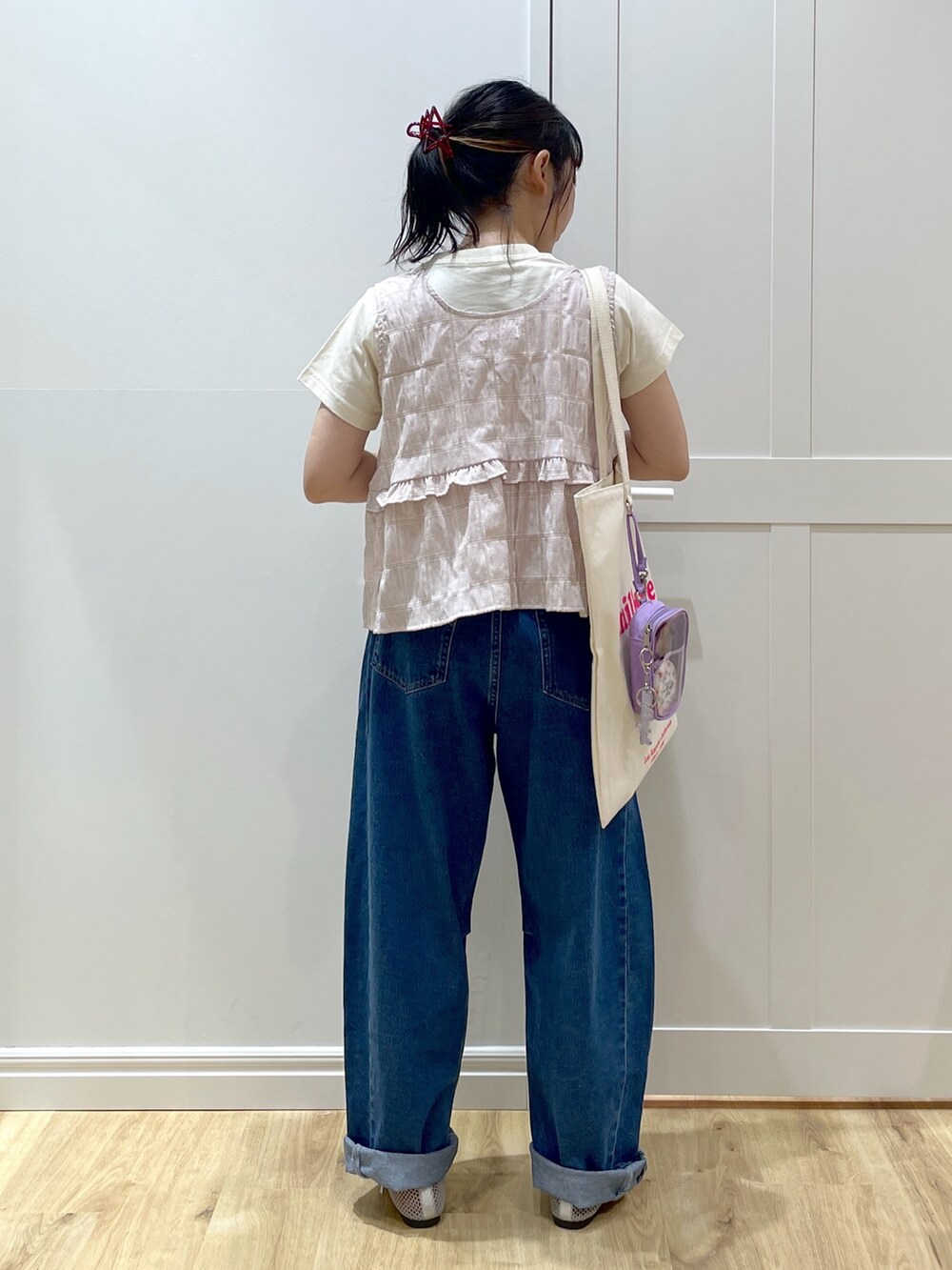 パープル系のタンクトップ、ホワイト系のTシャツ/カットソー、ブルー系のデニムパンツを着用したレディースの夏コーディネートの4枚目の写真