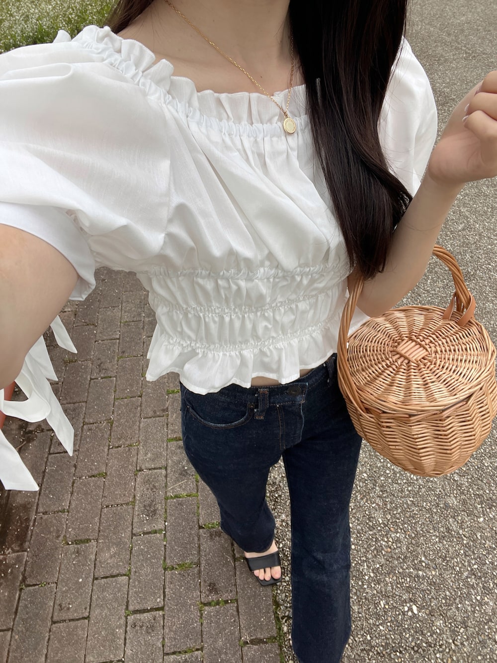 ホワイト系のシャツ/ブラウス、ブルー系のデニムパンツ、ベージュ系のかごバッグを着用したレディースの春コーディネートの3枚目の写真