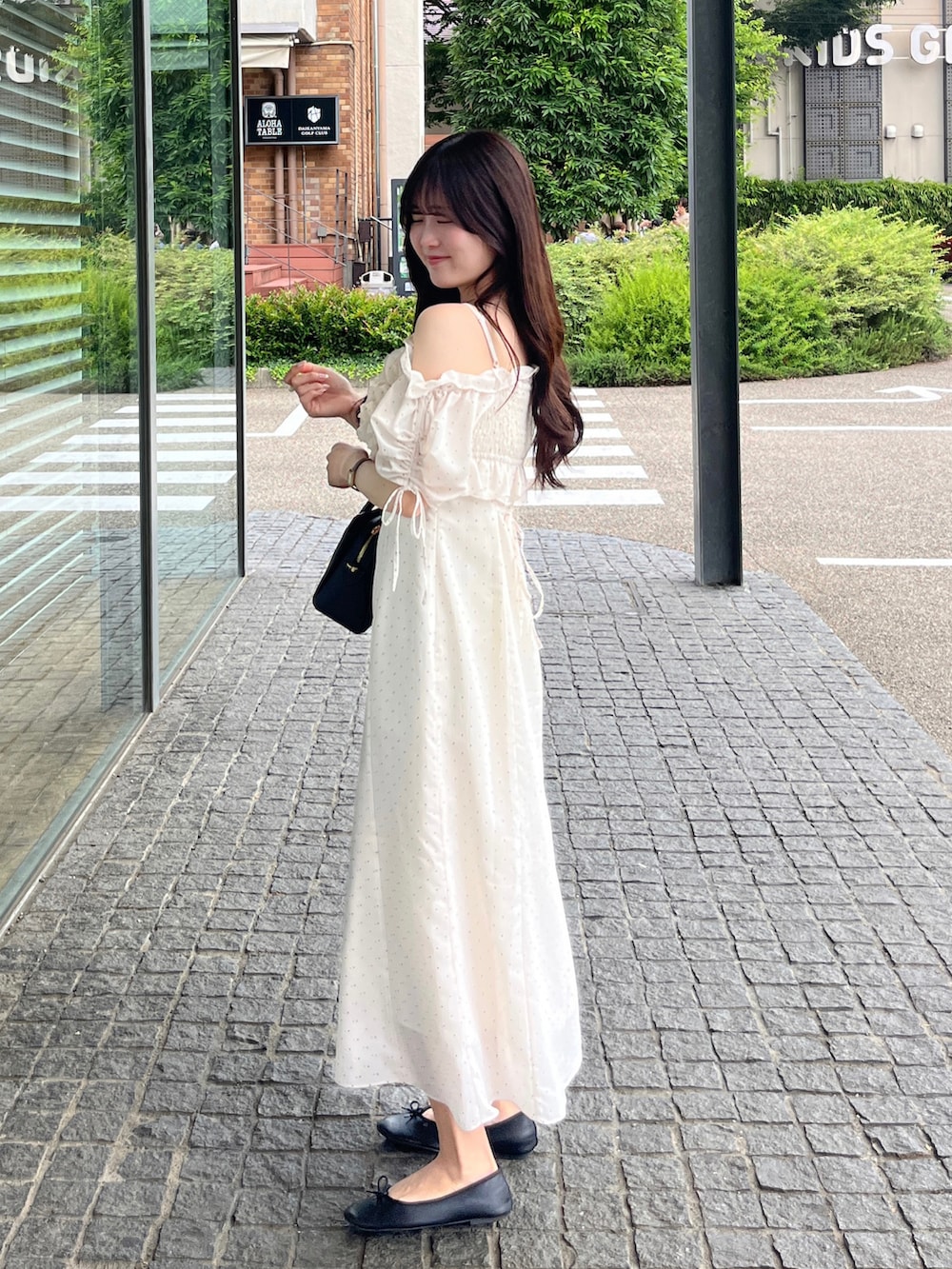 ブラック系のバッグ、その他のワンピースを着用したレディースの夏コーディネートの2枚目の写真