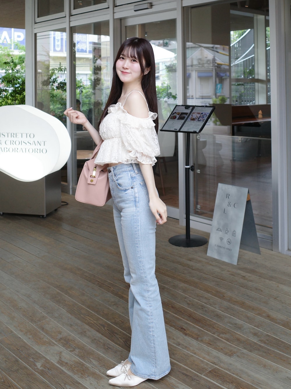 ホワイト系のシャツ/ブラウス、ピンク系のバッグ、ブルー系のデニムパンツを着用したレディースの春コーディネートの2枚目の写真