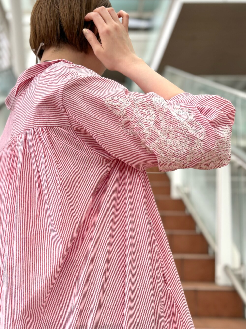 「ピンク、デニム、スニーカー、春コーデ、ストライプシャツ、刺繍、刺繍ワンピース、シャツワンピース、ワンピースコーデ、Tシャツ×デニム、白Tシャツ、ワンピーススタイル、高身長、高身長女子、高身長コーデ」｜「collexのチューブハンドル2WAYミニトートバッグ（トートバッグ、グレー系）」を使った、yukikoさん（レディース・166cm）の春コーディネートの2枚目の写真