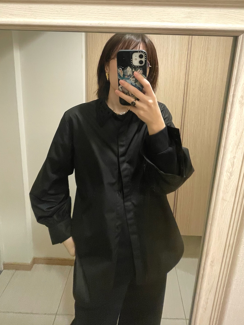 ブラック系のデニムパンツ、ブラック系のシャツ/ブラウス、ブラウン系のブーツを着用したレディースの秋コーディネートの2枚目の写真