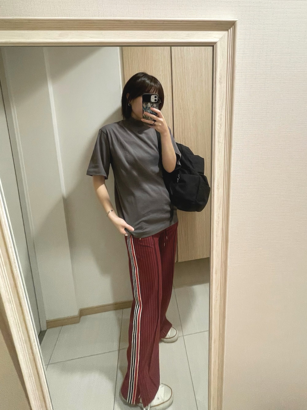 グレー系のTシャツ/カットソー、ホワイト系のスニーカー、レッド系のその他パンツを着用したレディースの秋コーディネートの2枚目の写真