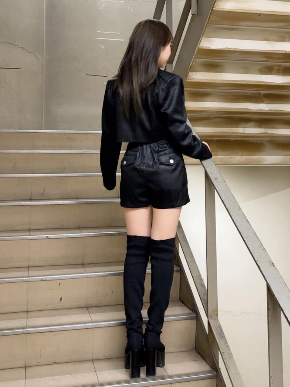 ブラック系のつなぎ/オールインワン、ブラック系のテーラードジャケット、ブラック系のブーツを着用したレディースの冬コーディネートの3枚目の写真