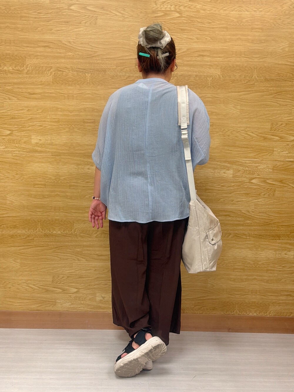 ブルー系のシャツ/ブラウス、ブラウン系のその他パンツ、シルバー系のショルダーバッグを着用したレディースの夏コーディネートの3枚目の写真