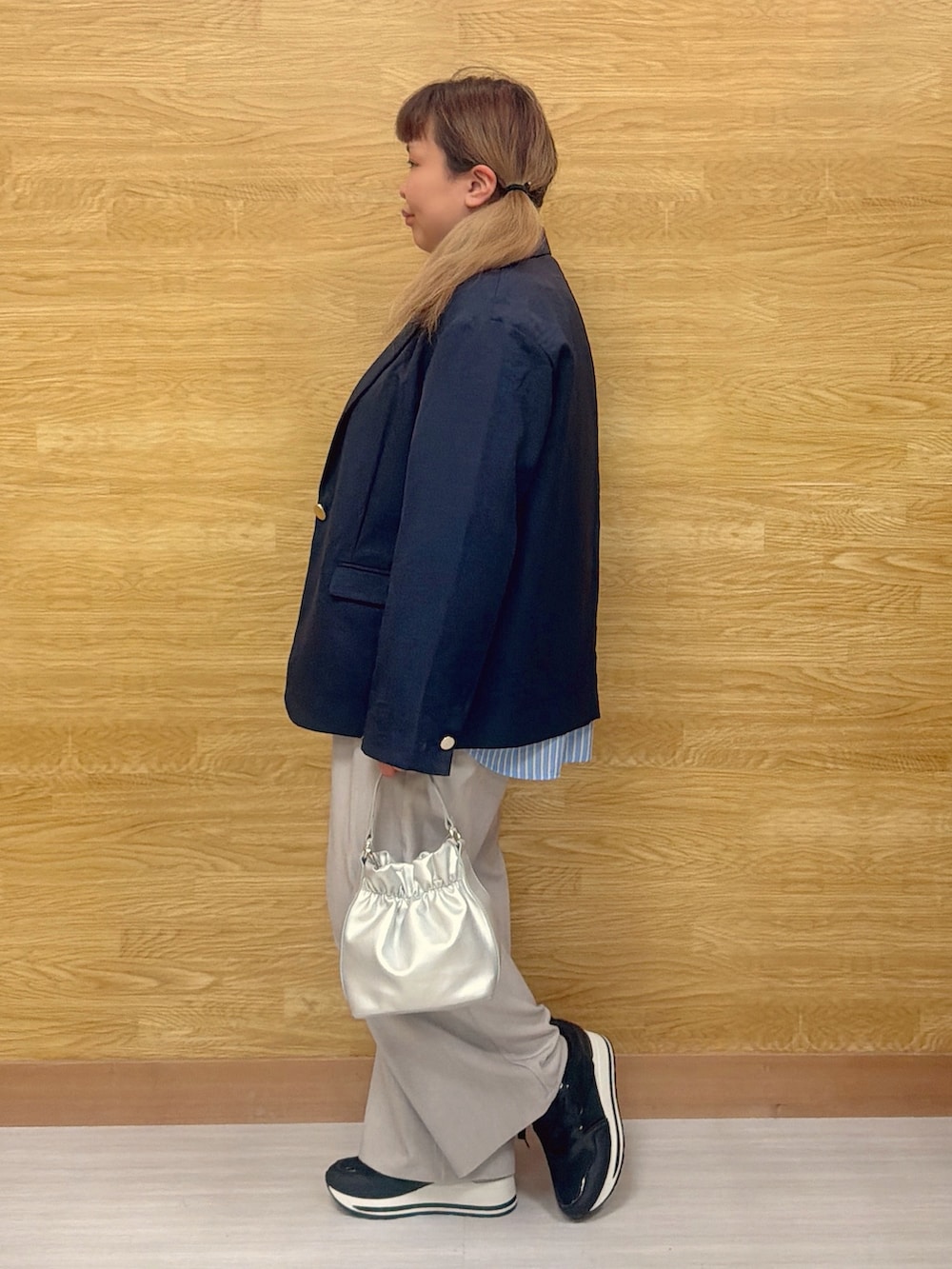 グレー系のその他パンツ、ブラック系のスニーカー、ブルー系のテーラードジャケットを着用したレディースの春コーディネートの2枚目の写真