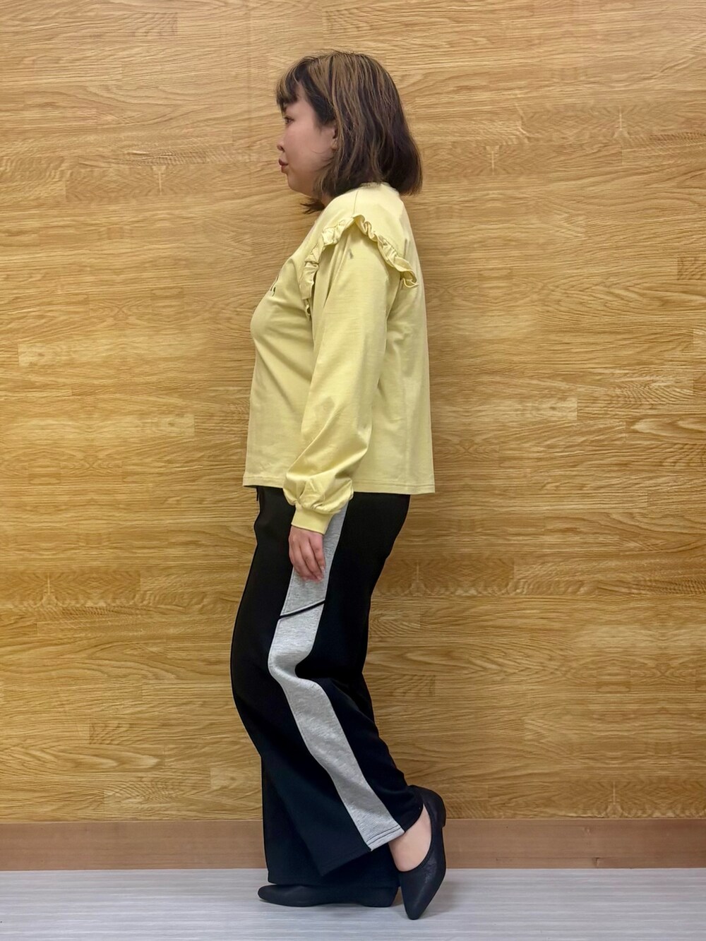 イエロー系のTシャツ/カットソー、ブラック系のその他パンツを着用したレディースの春コーディネートの2枚目の写真