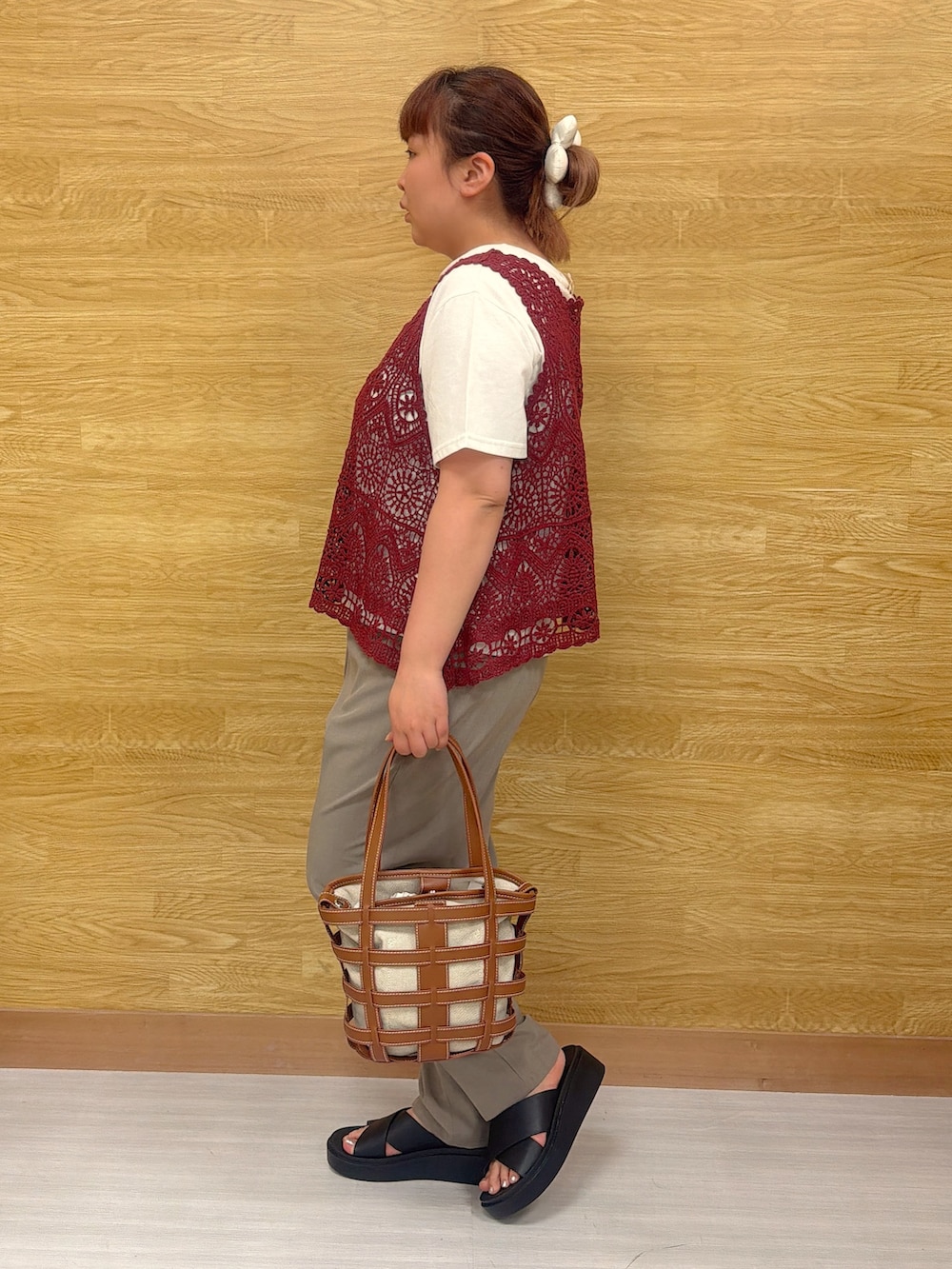 ブラウン系のその他パンツ、イエロー系のトートバッグ、ブラック系のサンダルを着用したレディースの春コーディネートの2枚目の写真