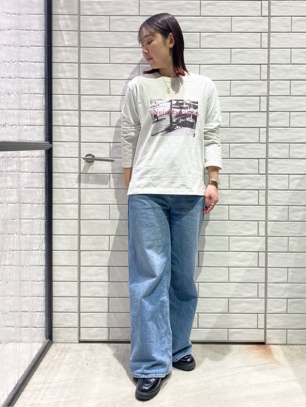 ブラック系のカーディガン/ボレロ、ホワイト系のTシャツ/カットソー、ブルー系のデニムパンツを着用したレディースの冬コーディネートの4枚目の写真