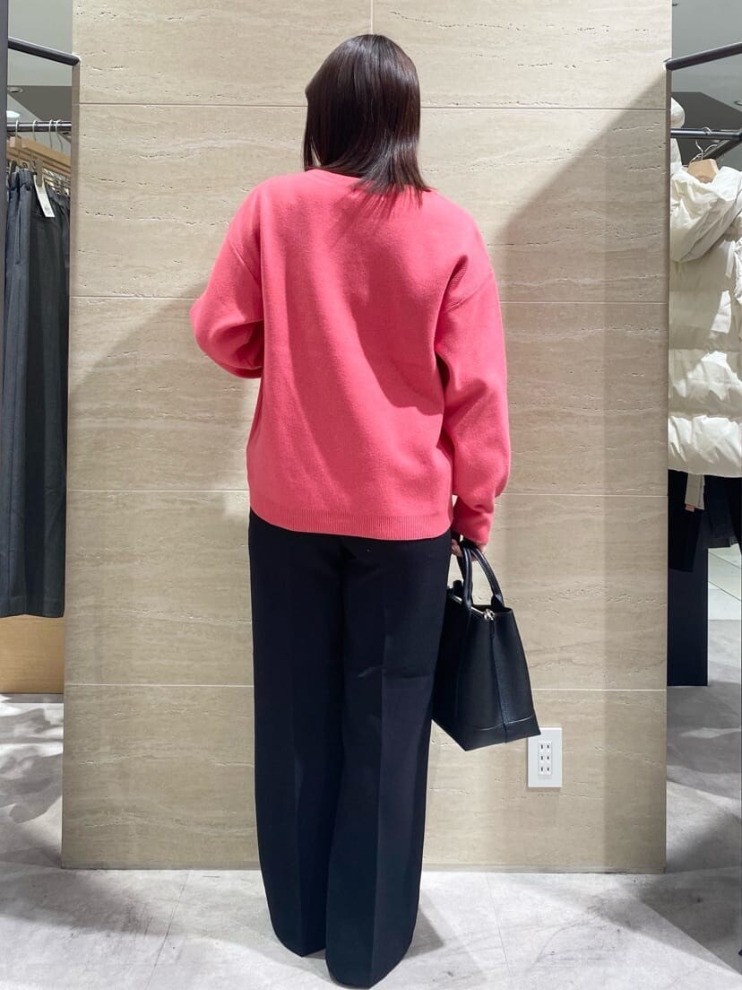 ピンク系のニット/セーター、ブラック系のその他パンツ、ブラック系のトートバッグを着用したレディースの冬コーディネートの2枚目の写真