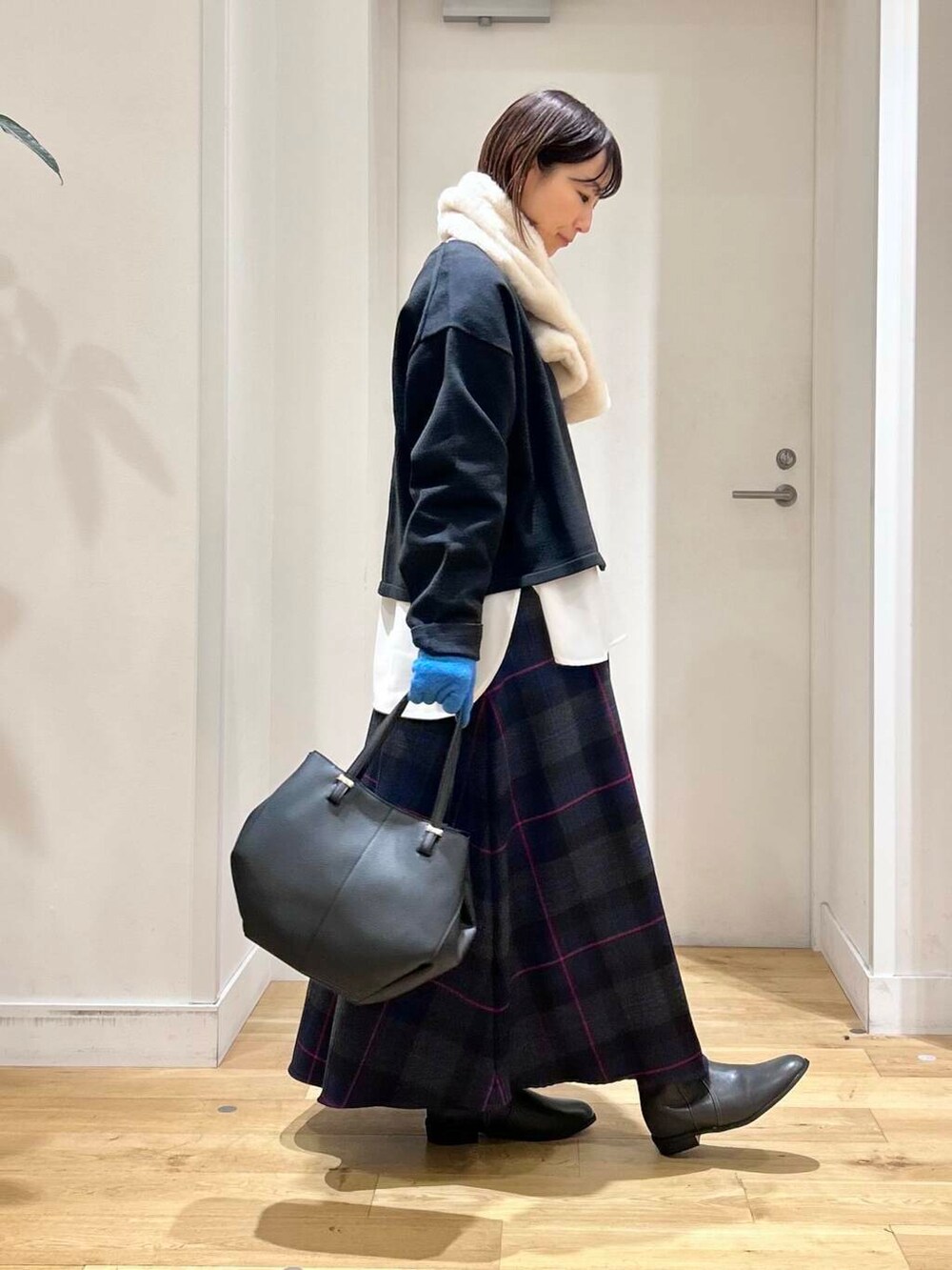 ブラック系のショルダーバッグ、グレー系のブーツ、ブラック系のカーディガン/ボレロを着用したレディースの秋コーディネートの4枚目の写真