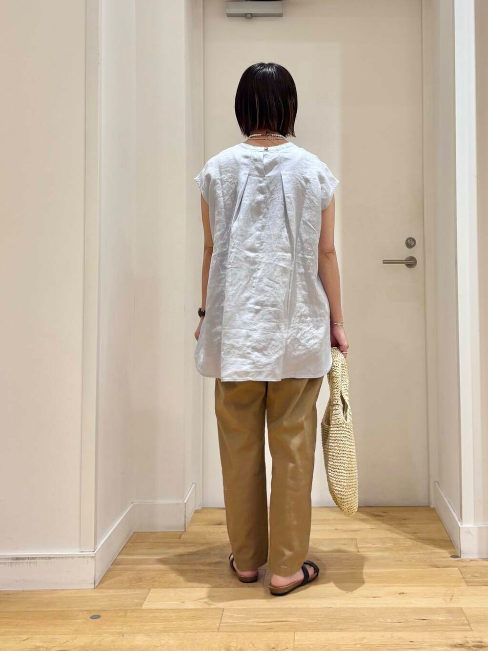 ベージュ系のトートバッグ、ベージュ系のその他パンツ、ブルー系のシャツ/ブラウスを着用したレディースの夏コーディネートの5枚目の写真