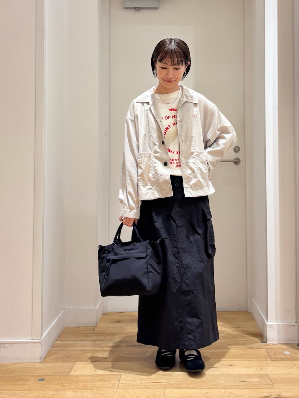 ホワイト系のTシャツ/カットソー、ベージュ系のテーラードジャケット、ブラック系のスカートを着用したレディースの春コーディネートの3枚目の写真