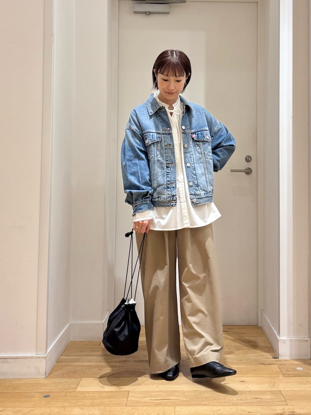 ホワイト系のシャツ/ブラウス、ブルー系のデニムジャケット、ベージュ系のその他パンツを着用したレディースの秋コーディネートの2枚目の写真