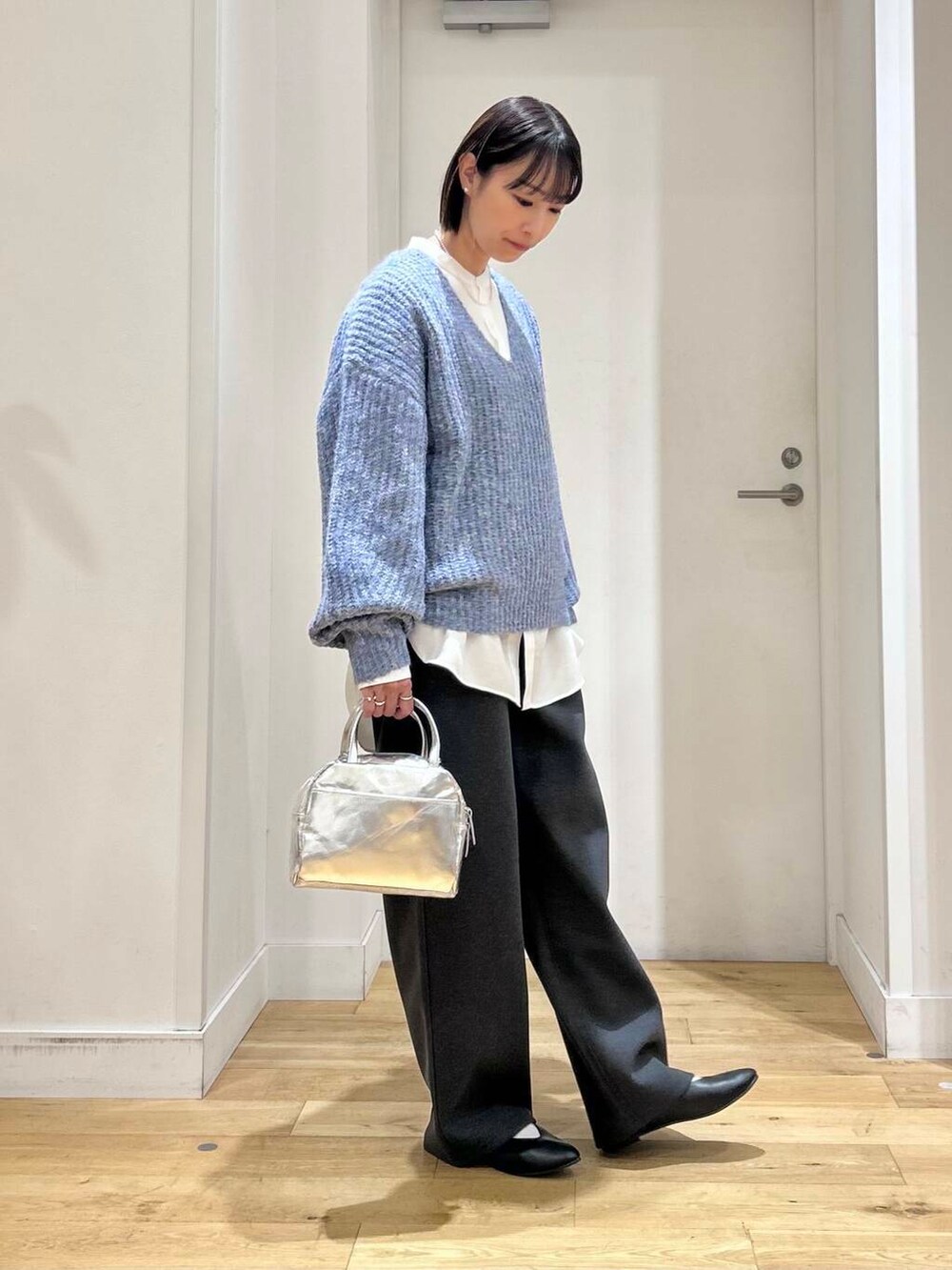 ブラック系のパンプス、ホワイト系のシャツ/ブラウス、グレー系のその他パンツを着用したレディースの冬コーディネートの4枚目の写真