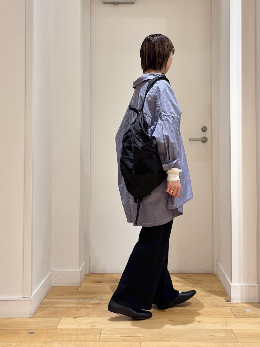 ブラック系のその他パンツ、ブラック系のパンプス、ブルー系のシャツ/ブラウスを着用したレディースの冬コーディネートの5枚目の写真