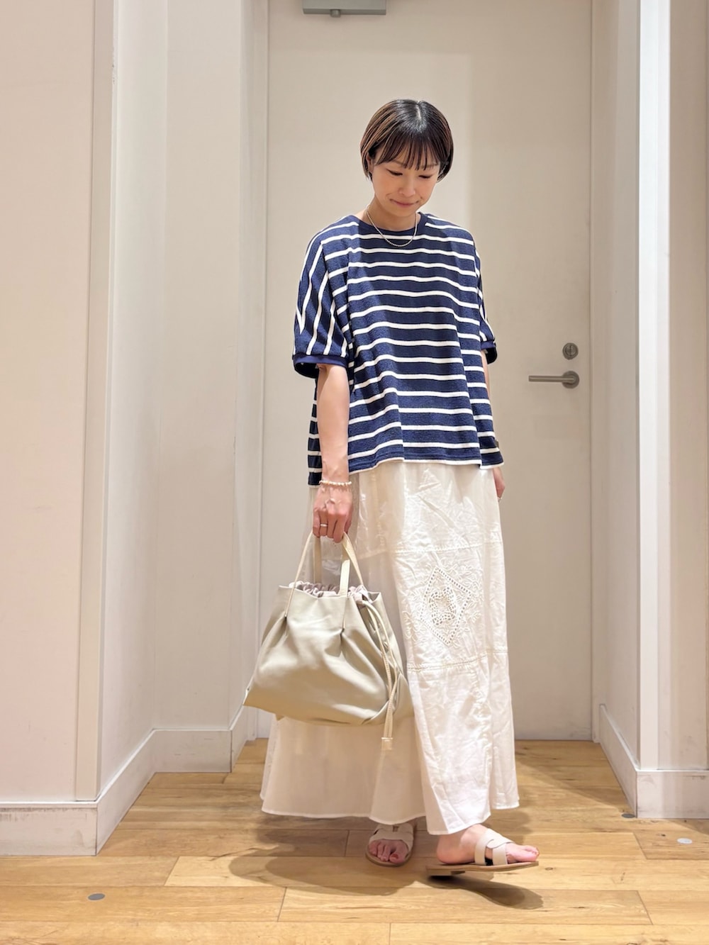 ブルー系のTシャツ/カットソー、ホワイト系のスカート、ホワイト系のショルダーバッグを着用したレディースの夏コーディネートの5枚目の写真