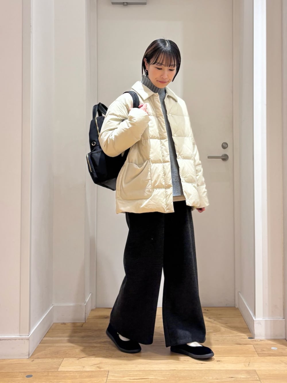 ホワイト系のダウンジャケット/コート、グレー系のその他パンツ、ブラック系のその他シューズを着用したレディースの冬コーディネートの4枚目の写真