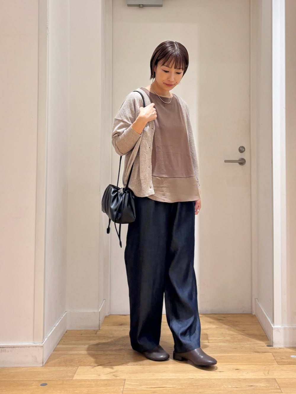 ブラウン系のTシャツ/カットソー、ブルー系のデニムパンツ、ベージュ系のカーディガン/ボレロを着用したレディースの夏コーディネートの4枚目の写真