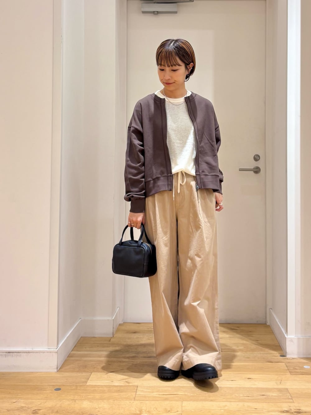 ベージュ系のその他パンツ、ホワイト系のTシャツ/カットソー、ブラウン系のカーディガン/ボレロを着用したレディースの秋コーディネートの4枚目の写真