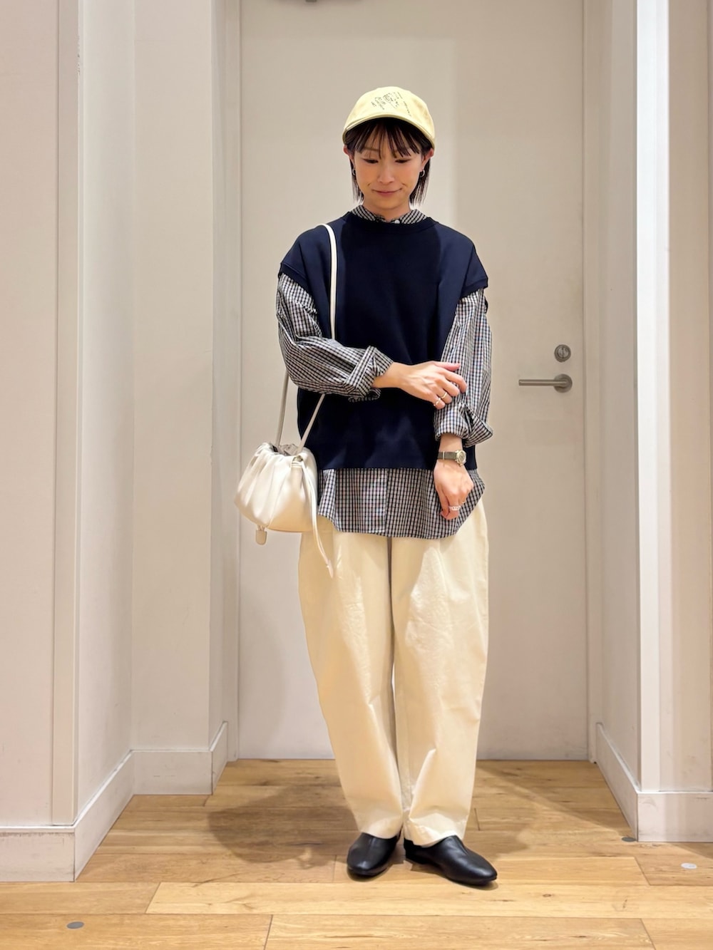 ブラック系のシャツ/ブラウス、ブルー系のベスト、ホワイト系のその他パンツを着用したレディースの冬コーディネートの2枚目の写真