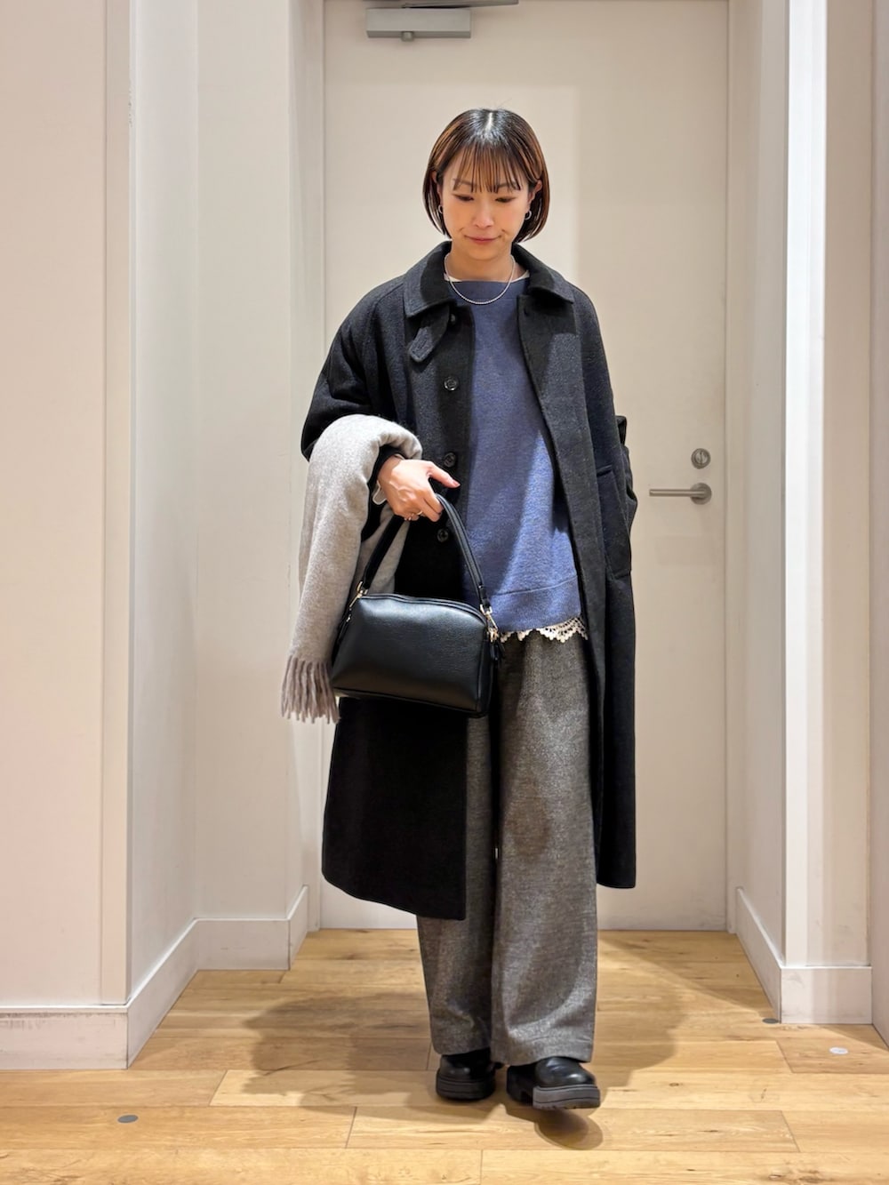 ブルー系のニット/セーター、グレー系のその他パンツ、ホワイト系のTシャツ/カットソーを着用したレディースの冬コーディネートの2枚目の写真