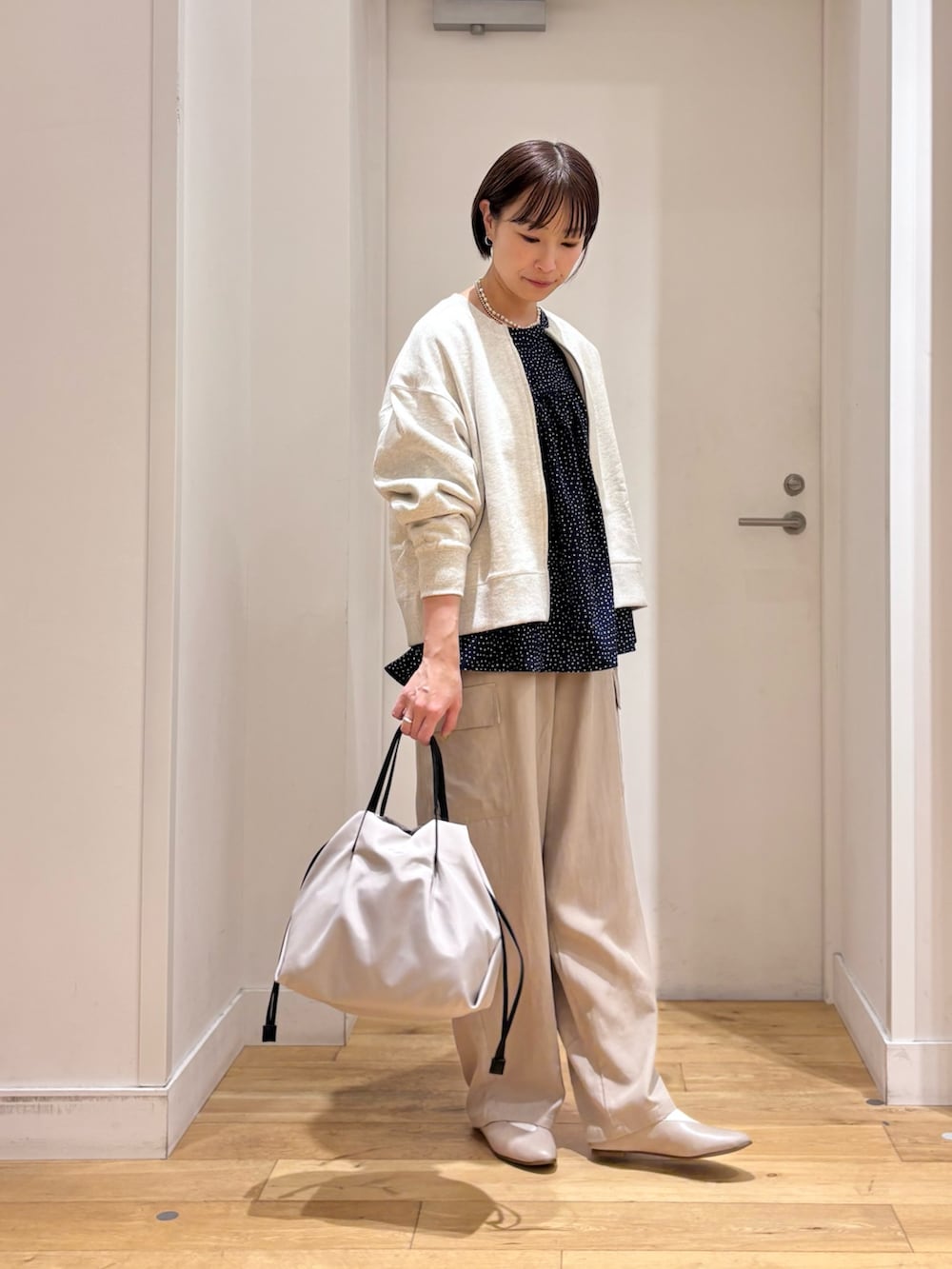 ホワイト系のカーディガン/ボレロ、ブルー系のシャツ/ブラウス、ベージュ系のその他パンツを着用したレディースの春コーディネートの5枚目の写真