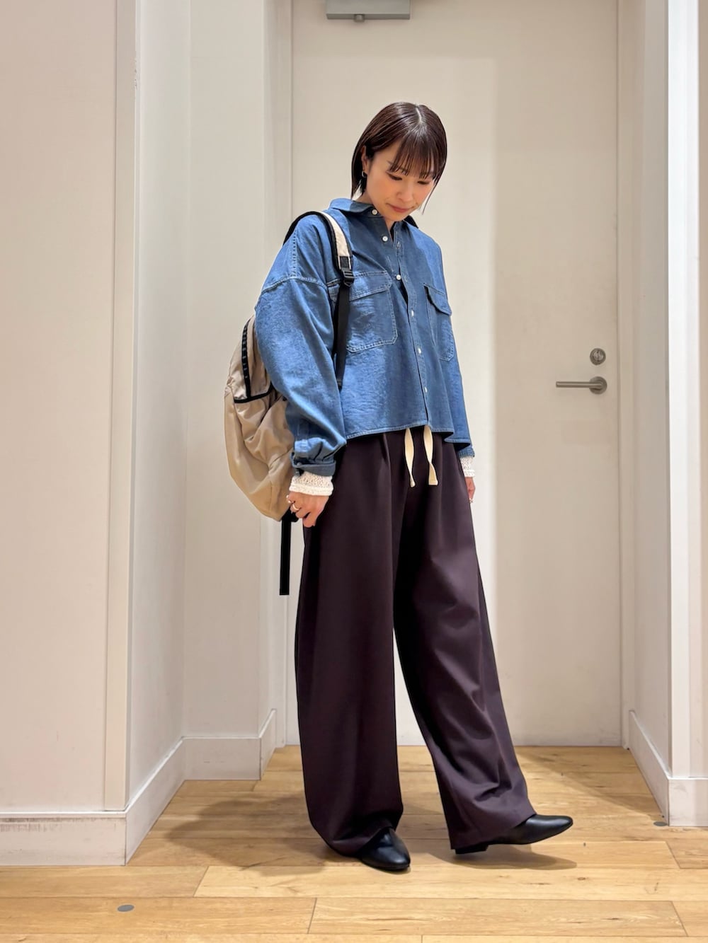 ブルー系のシャツ/ブラウス、ブラウン系のその他パンツ、ベージュ系のバックパック/リュックを着用したレディースの冬コーディネートの4枚目の写真