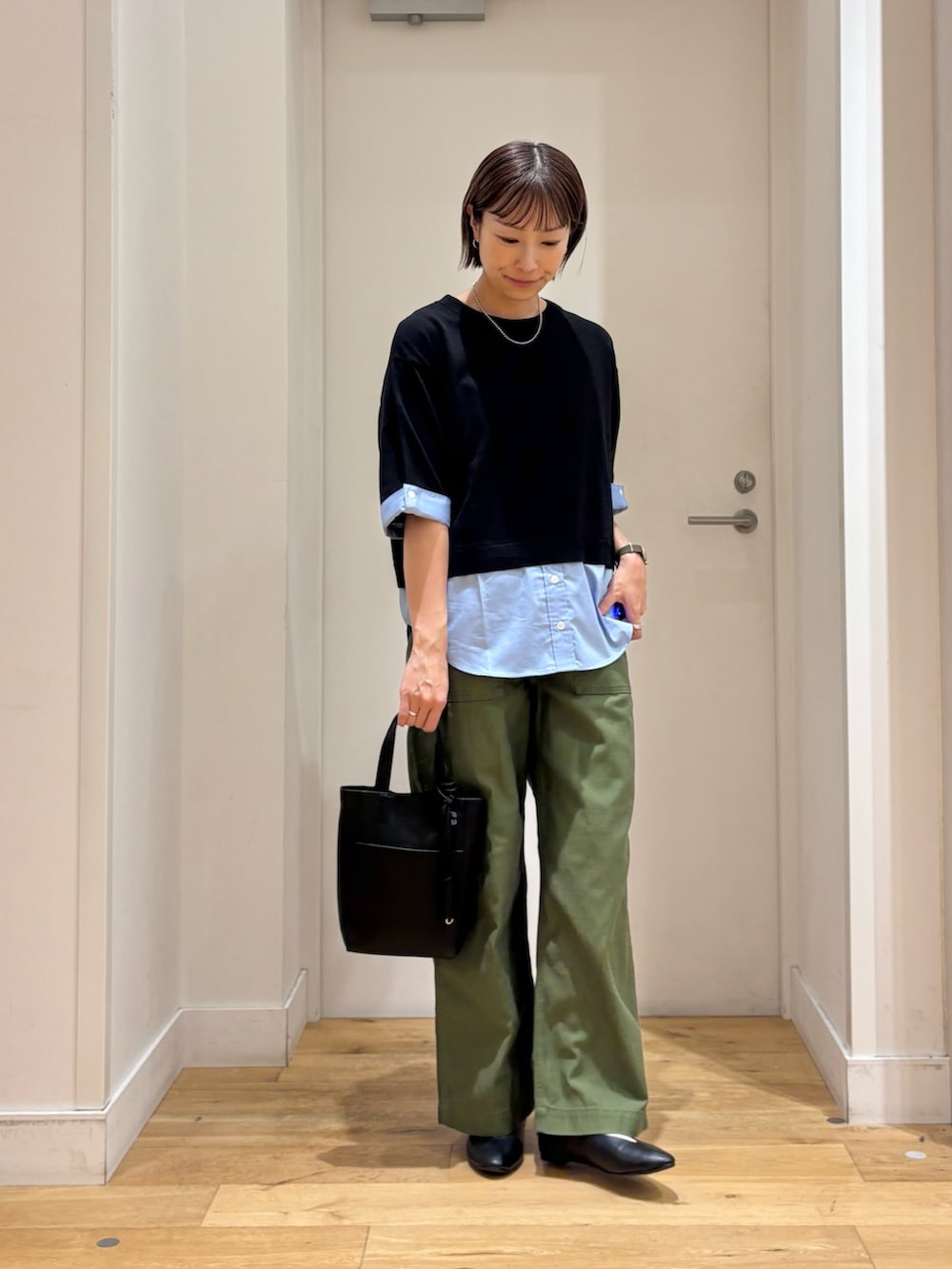 グリーン系のその他パンツ、ブラック系のニット/セーター、ブラック系のトートバッグを着用したレディースの秋コーディネートの4枚目の写真