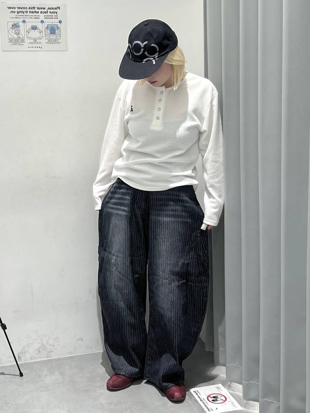ホワイト系のTシャツ/カットソー、ブラック系のデニムパンツ、ブラック系のキャップを着用したレディースの秋コーディネートの3枚目の写真