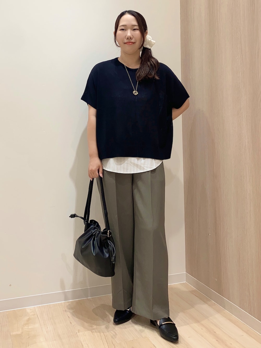 グリーン系のその他パンツ、ブラック系のショルダーバッグ、ゴールド系のネックレスを着用したレディースの秋コーディネートの6枚目の写真